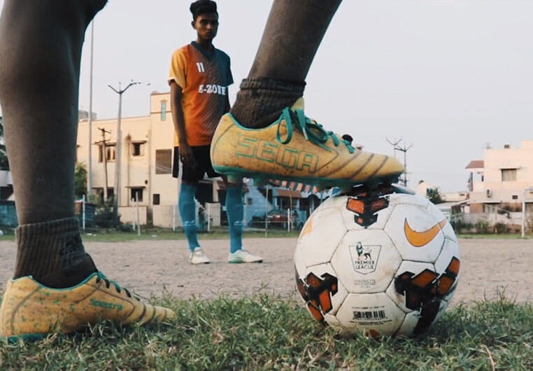 Indian teenagers playing soccer.